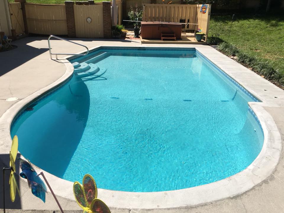 Backyard pool with water feature lighting