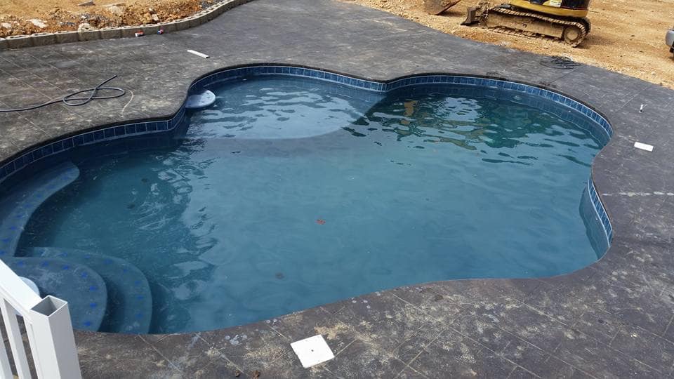 Geometric pool with stone patio